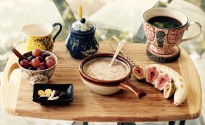 Breakfast foods laid out on a wooden plate