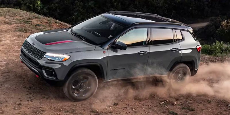 Jeep cruising through rugged terrain, showcasing its off-road capability and adventure-ready design.